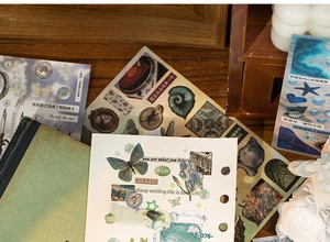 Close-up of vintage decorative stickers with floral and butterfly patterns for scrapbooking