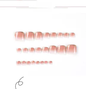 Detail of pink gradient toe nails with golden glitter tips and various sizes set
