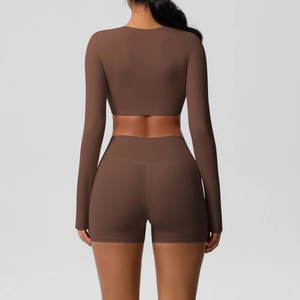 Women's brown yoga set with long sleeve crop top and high waist shorts from back view