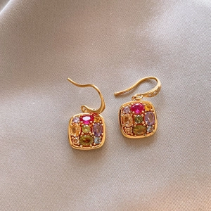 Detailed close-up of 18k gold-plated earrings with colorful square-framed zircon gemstones