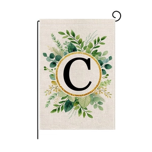 Christmas garden flag with letter C monogram and green leaf wreath on burlap texture