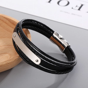 Detail of multi-layer leather bracelet with brushed stainless steel bar and magnetic clasp