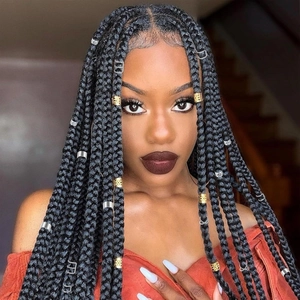 Detailed view of gold and silver metal rings used as accessories for long hair braids