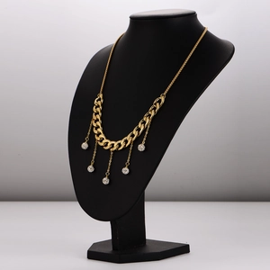 Gold cuban chain necklace with diamond-encrusted spheres on a black mannequin