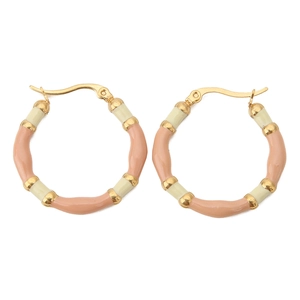 Detail of pink and cream enamel bamboo style hoop earrings with gold metal finish
