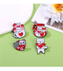 Detail shot of four cute cat enamel pins featuring coffee cups and heart shapes