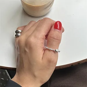 Close-up of a 925 sterling silver beaded open ring with a polished glossy finish