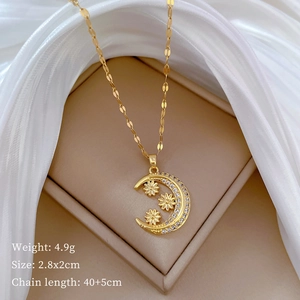 Macro shot of gold crescent flower necklace with cubic zirconia on silk jewelry box