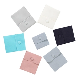 Thick velvet jewelry pouch set with snap buttons in various colors on white background