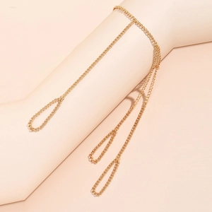 Golden chain bracelet ring set with star and butterfly charms on a hand model