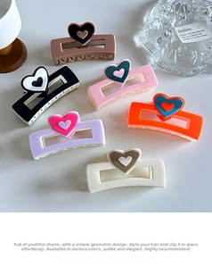 Detailed set of six colorful square hair claws with heart accents on a white table