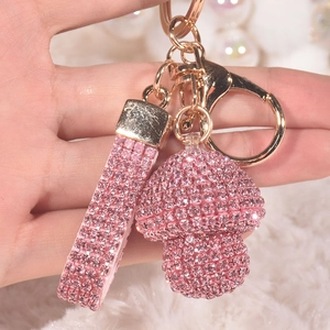Pink crystal mushroom keychain with rhinestone lanyard on soft white background