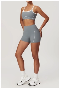 Detail of grey yoga set with white contrast piping and high-waist sports shorts