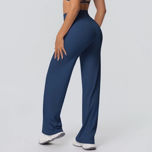 Side-rear view showing the high-waist fit and flared hem of dark blue yoga pants