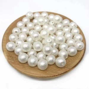 White ABS textured wrinkled faux pearl beads for DIY necklace jewelry making on wood tray