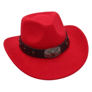 Detail of red cowboy hat featuring a black studded band and silver bull head buckle
