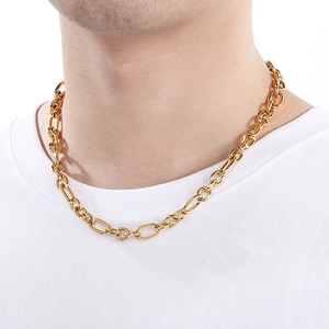 Macro detail of a 9mm gold-plated titanium steel link chain worn on a white t-shirt