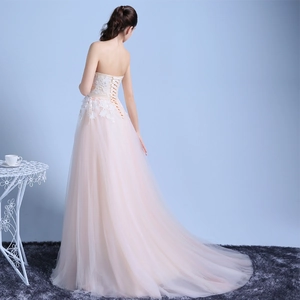 Elegant strapless champagne evening gown with lace embroidery and a long mesh train