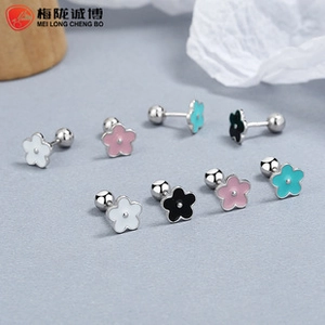 Detail of four colorful cherry blossom 925 silver stud earrings with screw ball backs