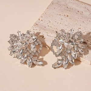 Detailed view of luxury silver flower earrings featuring sparkling marquise cut crystals