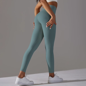 Detail showing high-waist design and elastic fabric of Morandi blue-green yoga pants