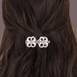 Macro detail of bridal silver flower hair clip with sparkling rhinestones in hair
