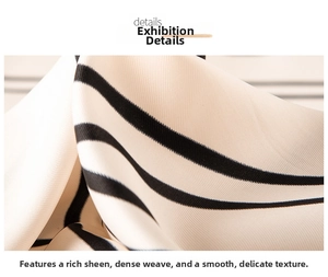 Detailed close-up of glossy black and white striped silk fabric texture and fine weaving