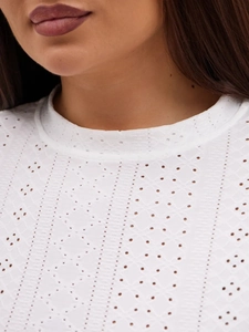 Close-up of white eyelet fabric with geometric hollow patterns and vertical stripes