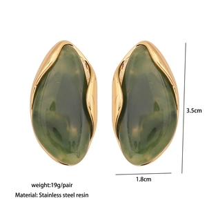 Detail view of gold geometric earrings with green resin showing dimensions and weight info