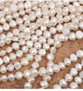 Macro view of 9-10mm white baroque freshwater pearls with high-quality natural luster