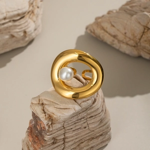 Close-up of 18K gold plated stainless steel ring with a white pearl on a stone base
