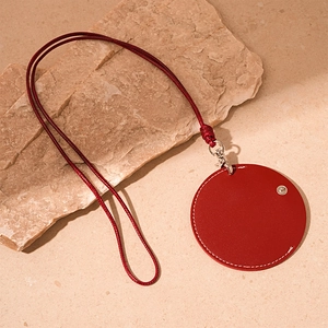 Macro detail of red faux leather mini pouch necklace with contrast white stitching