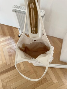 Interior view of lace tote bag showing large capacity, inner lining, and zipper pocket