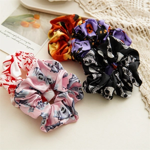 Five-pack Halloween satin scrunchies featuring skull, bat, pumpkin and ghost prints