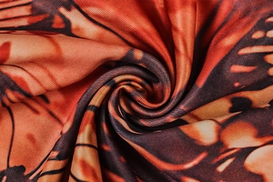 Macro shot of orange and black butterfly wing print on high-quality woven fabric texture