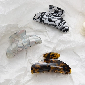Three large leopard print acetate shark hair claws in assorted neutral tortoiseshell patterns