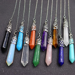 Array of multi-colored hexagonal crystal column pendants with polished metal caps and chains