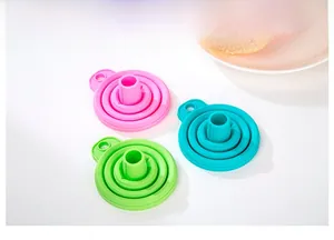 Close-up of three colorful foldable silicone funnels for kitchen and travel liquids