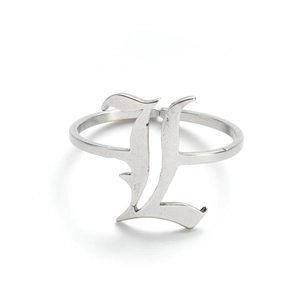 Macro view of vintage stainless steel ring with gothic uppercase letter L design