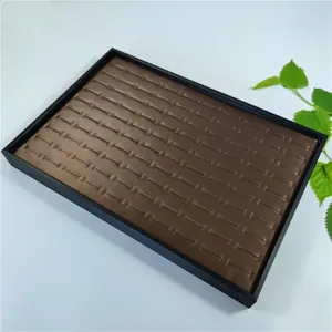 Black frame 100-slot jewelry display tray for rings and earrings in brown leather