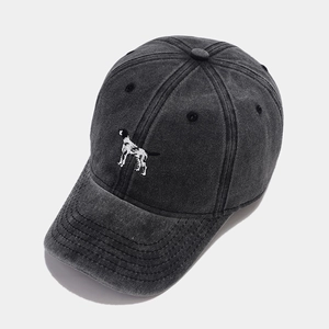 Detailed view of dog embroidery on a vintage washed grey cotton baseball cap