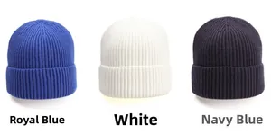 Three knitted beanie hats in royal blue, white, and navy blue with ribbed texture