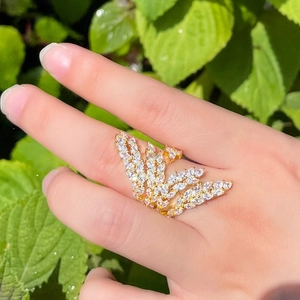 Adjustable gold angel wing ring with sparkling marquise zircon stones on finger