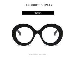Detailed macro view of black oversized round frames with elegant gold rivet accents