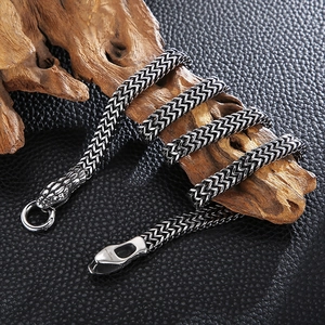 Vintage stainless steel snake head chain necklace with antique finish on aged wood