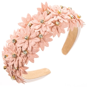 Detail of light pink floral headband with layered leather petals and rhinestone centers