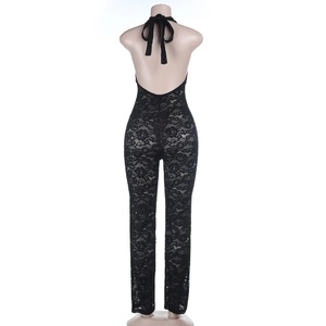 Detail of black lace jumpsuit showing backless halter neck design on a mannequin