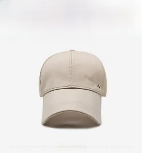 Detail view of beige mesh baseball cap featuring side SPORT embroidery and air vents