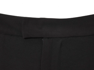 Close-up of the waistband detail and stitching on black casual straight-leg trousers