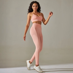 Pink seamless yoga set featuring a strappy sports bra and high waisted compression leggings